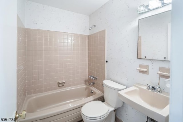 full bathroom with a sink, washtub / shower combination, and toilet