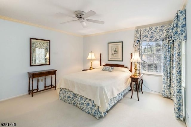 bedroom with crown molding, baseboards, carpet, and a ceiling fan