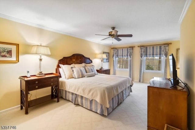 bedroom featuring crown molding, a ceiling fan, baseboards, and light carpet