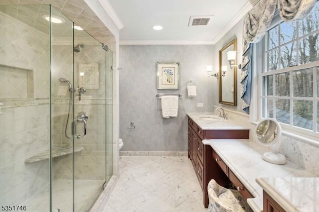 bathroom featuring vanity, baseboards, a shower stall, visible vents, and ornamental molding