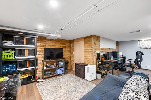 living room featuring wood finished floors and wooden walls