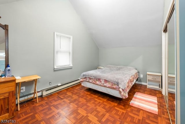 bedroom featuring lofted ceiling and baseboard heating