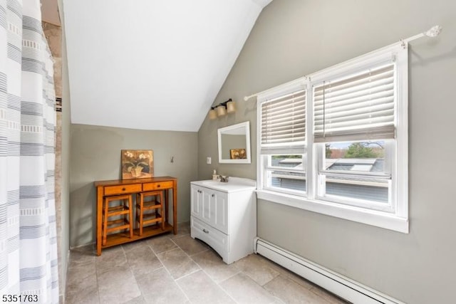 full bathroom with vanity, baseboard heating, a shower with curtain, and lofted ceiling