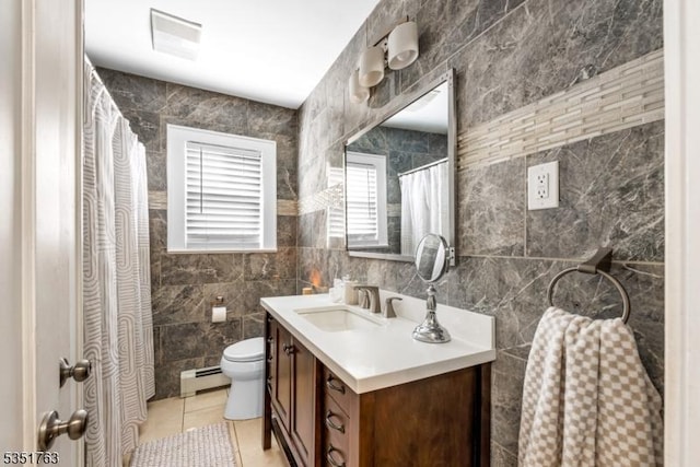 full bathroom featuring tile patterned flooring, vanity, toilet, tile walls, and a baseboard radiator