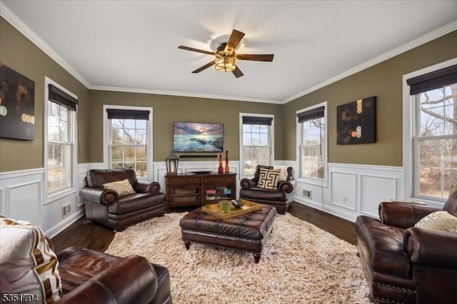 living room with plenty of natural light, visible vents, ceiling fan, and dark wood finished floors