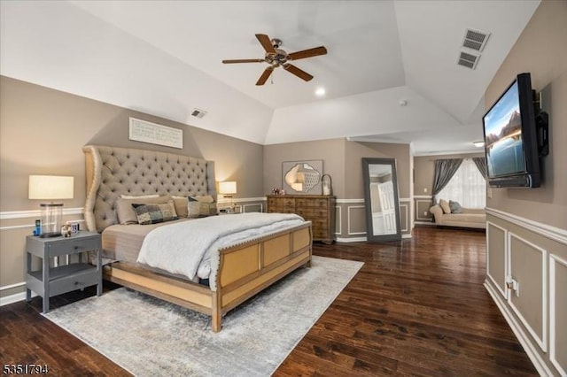 bedroom with visible vents, wood finished floors, and vaulted ceiling