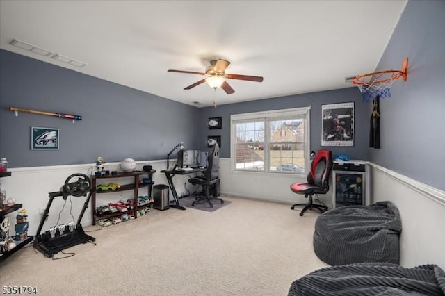interior space with visible vents, a ceiling fan, and carpet flooring