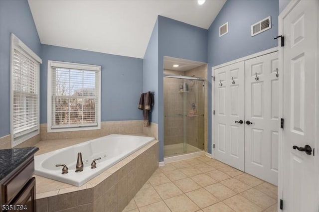 full bathroom with visible vents, a bath, and vaulted ceiling