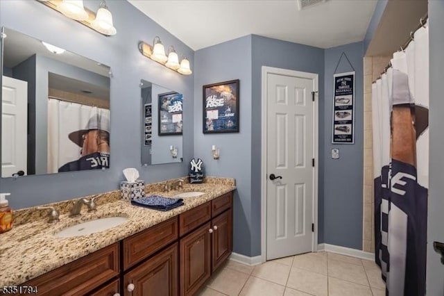 full bath with tile patterned flooring, a sink, double vanity, and baseboards