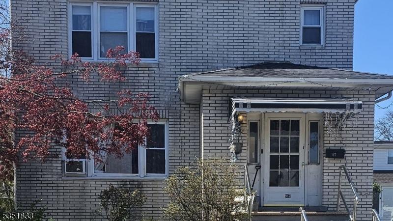 doorway to property with brick siding