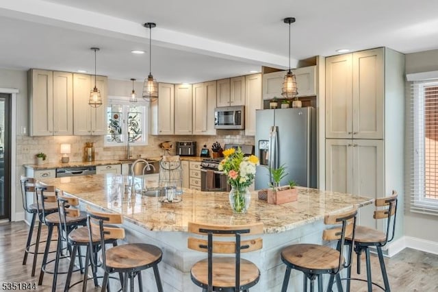 kitchen with plenty of natural light, a sink, and appliances with stainless steel finishes
