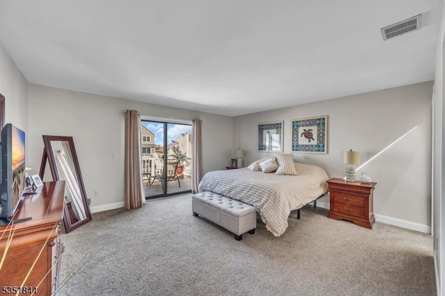 carpeted bedroom with baseboards, access to exterior, and visible vents