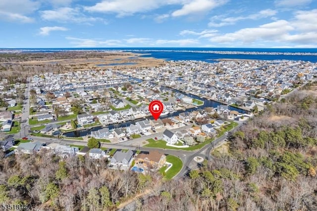 drone / aerial view featuring a water view and a residential view