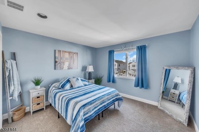 bedroom with baseboards, visible vents, and carpet
