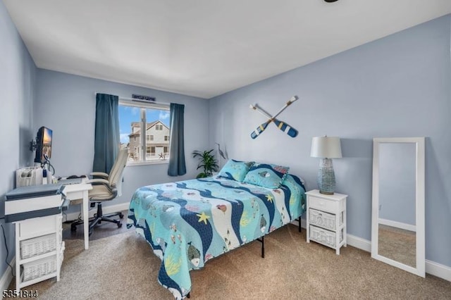 carpeted bedroom with baseboards