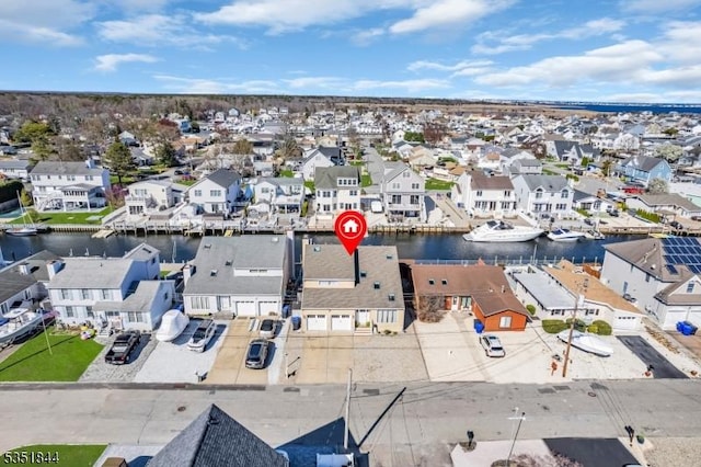 drone / aerial view with a water view and a residential view