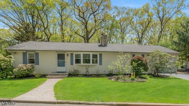 single story home featuring a front lawn and a chimney