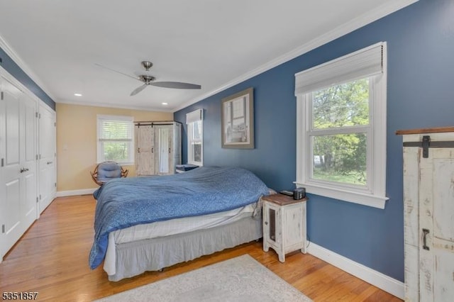 bedroom with crown molding, baseboards, and wood finished floors