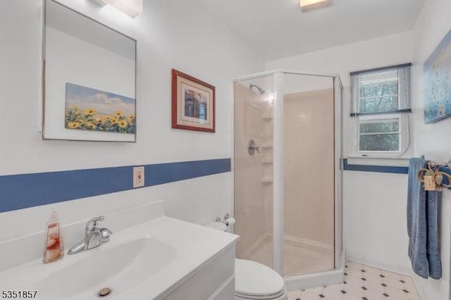 full bathroom with vanity, tile patterned floors, toilet, and a shower stall