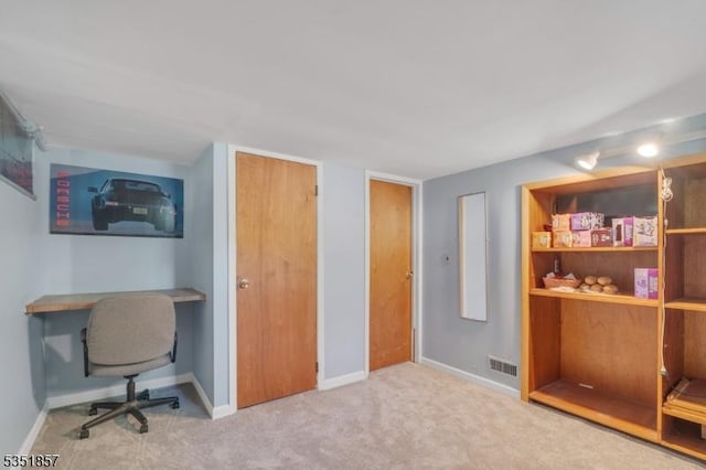 carpeted home office with baseboards and visible vents