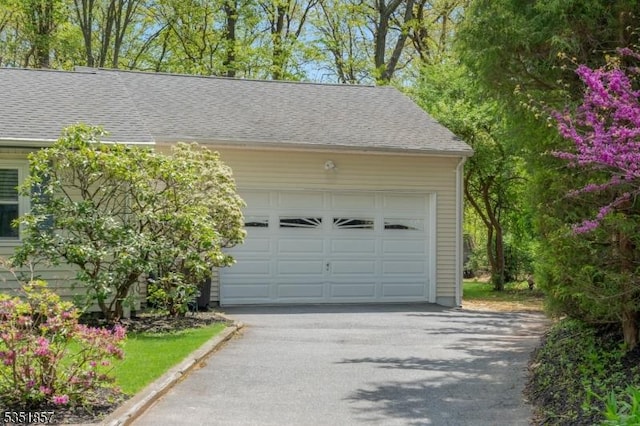garage with aphalt driveway