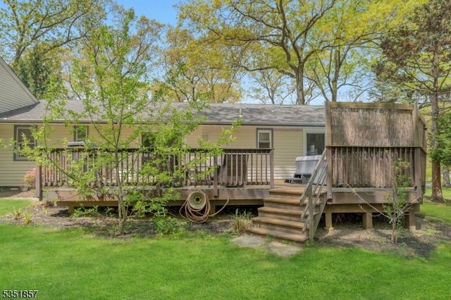 back of house featuring a lawn and a wooden deck