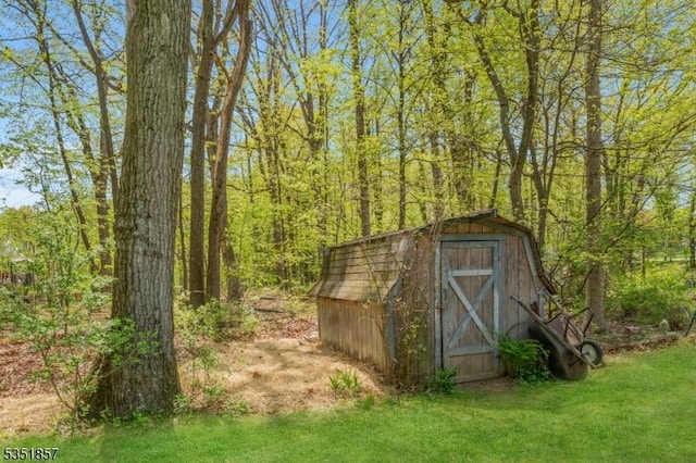 view of shed with a view of trees