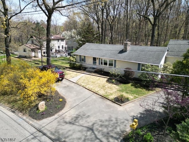 single story home featuring a chimney
