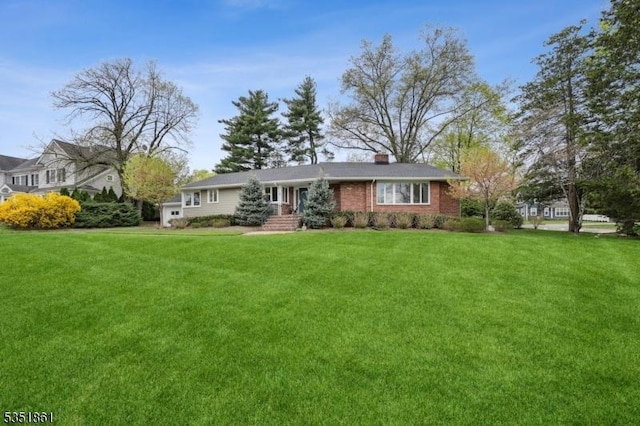 1 Noe Ave, Madison Boro, NJ 07940 - view of front facade featuring brick siding, a chimney, and a front yard