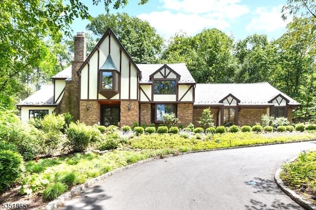70 Friar Ln, Watchung Boro, NJ 07069 - tudor home featuring a chimney, stucco siding, and brick siding