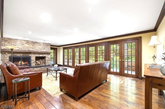 70 Friar Ln, Watchung Boro, NJ 07069 - living area with french doors, wood finished floors, plenty of natural light, a brick fireplace, and ornamental molding
