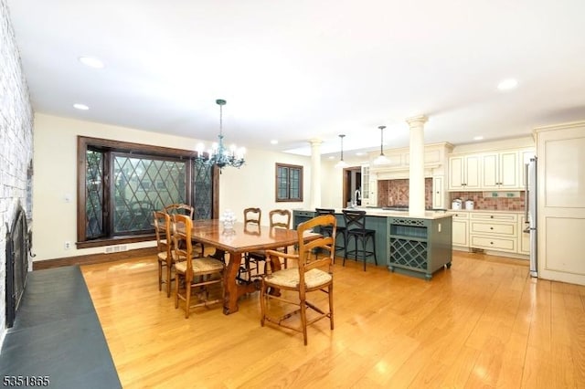 70 Friar Ln, Watchung Boro, NJ 07069 - dining area featuring light wood-type flooring, a chandelier, recessed lighting, and a large fireplace
