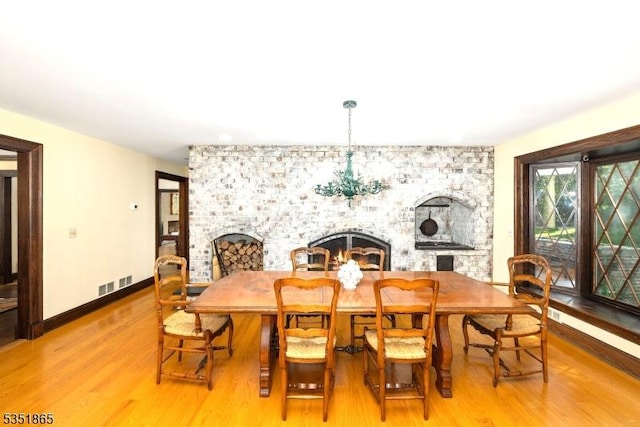 70 Friar Ln, Watchung Boro, NJ 07069 - dining area with light wood-type flooring, baseboards, and a chandelier