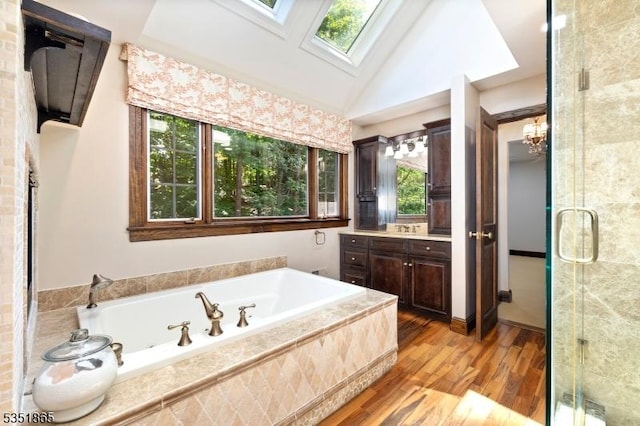 70 Friar Ln, Watchung Boro, NJ 07069 - bathroom featuring a skylight, a garden tub, wood finished floors, a shower stall, and vanity