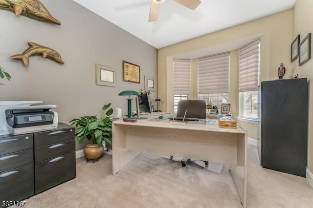 office area featuring carpet floors, ceiling fan, and baseboards