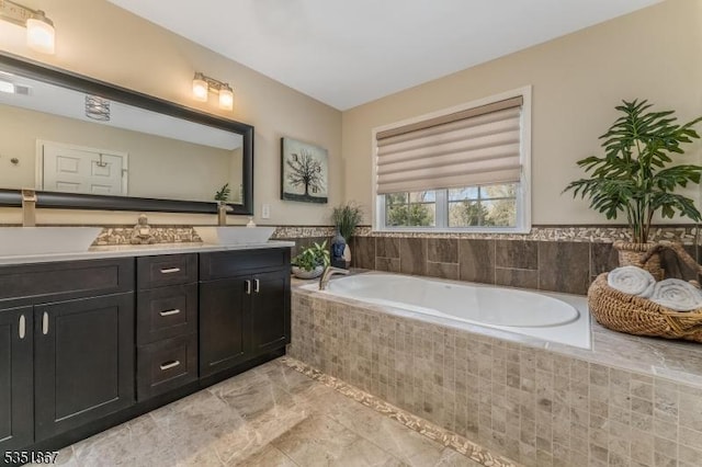 bathroom with a sink, double vanity, and a bath