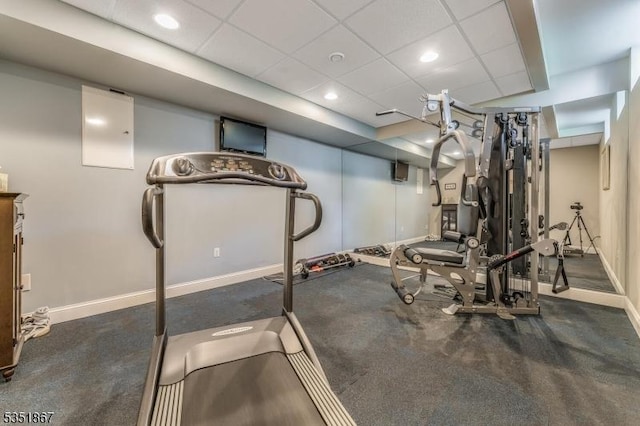 workout area featuring recessed lighting, baseboards, and a paneled ceiling