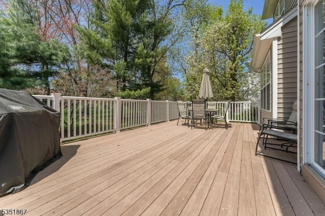 wooden terrace with outdoor dining space