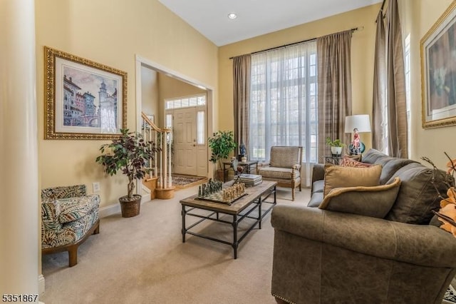 living area with baseboards and carpet