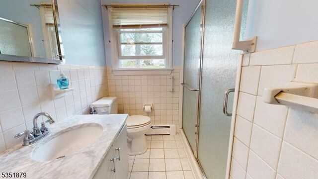 11 Kory Rd, Newton Town, NJ 07860 - bathroom featuring toilet, tile patterned floors, tile walls, a baseboard heating unit, and a stall shower