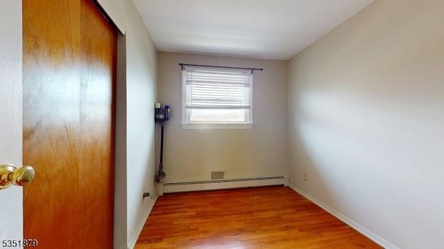 11 Kory Rd, Newton Town, NJ 07860 - empty room featuring baseboards, light wood finished floors, and a baseboard heating unit