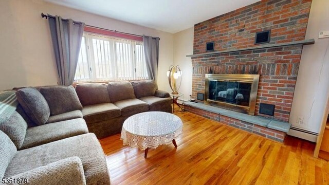 11 Kory Rd, Newton Town, NJ 07860 - living area featuring wood finished floors, baseboard heating, and a fireplace