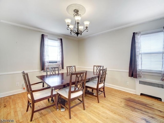 329 Hobson St, Newark City, NJ 07112 - dining room featuring radiator, a chandelier, light wood-type flooring, crown molding, and baseboards
