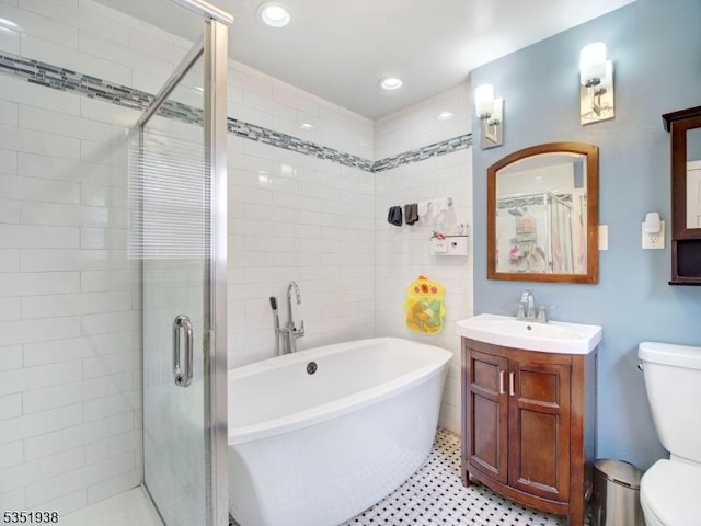 329 Hobson St, Newark City, NJ 07112 - bathroom featuring toilet, a freestanding tub, a shower stall, vanity, and recessed lighting