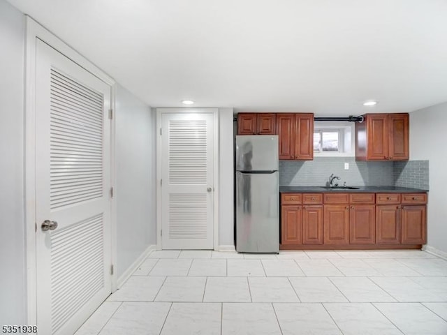 329 Hobson St, Newark City, NJ 07112 - kitchen featuring freestanding refrigerator, a sink, dark countertops, baseboards, and backsplash
