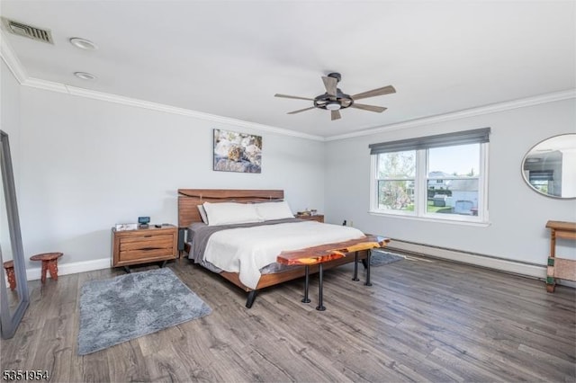 bedroom with crown molding, visible vents, wood finished floors, baseboards, and a baseboard radiator