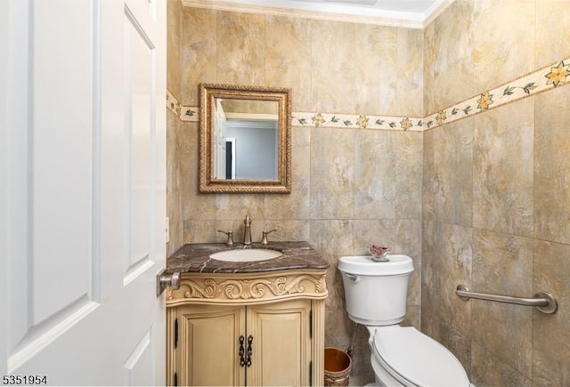 half bathroom featuring vanity and toilet