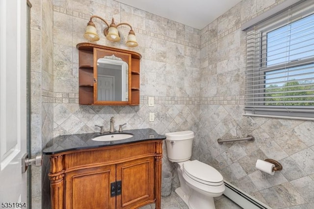 bathroom with toilet, tile walls, a baseboard heating unit, and vanity