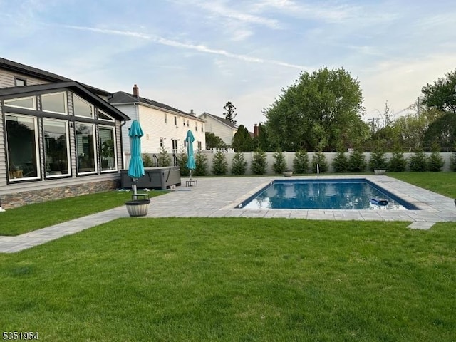 view of pool with a yard, a fenced in pool, a fenced backyard, and a patio area