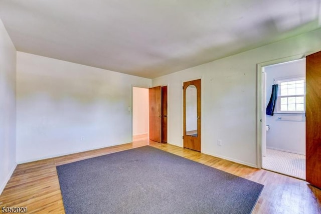 empty room with baseboards and light wood-style floors